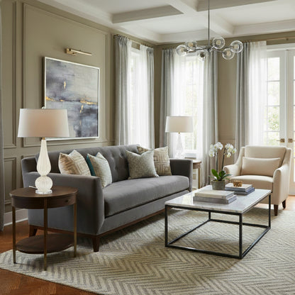 A white glass lamp in a transitional living room setting.