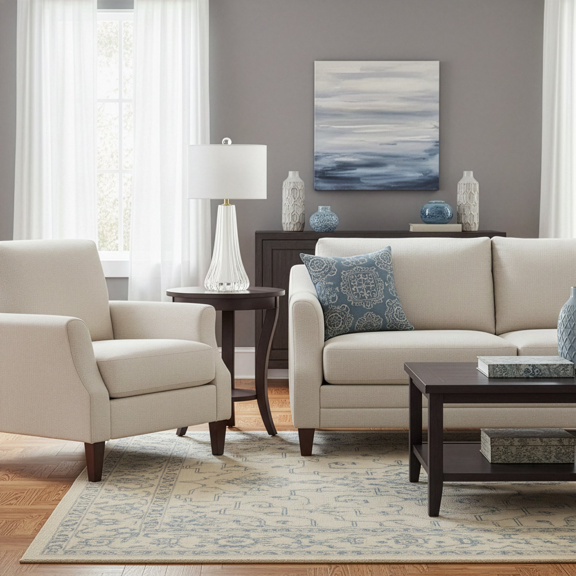 Living room with beige sofa, armchair, and coffee table with a white Murano glass lamp.