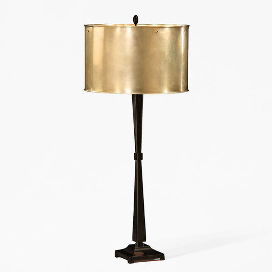 Black table lamp with antique brass lampshade.