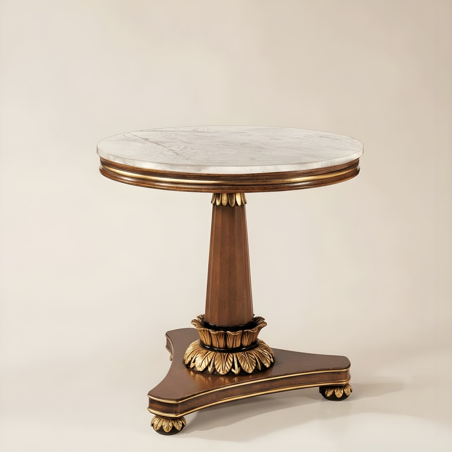 Round marble table with gold base on a beige background