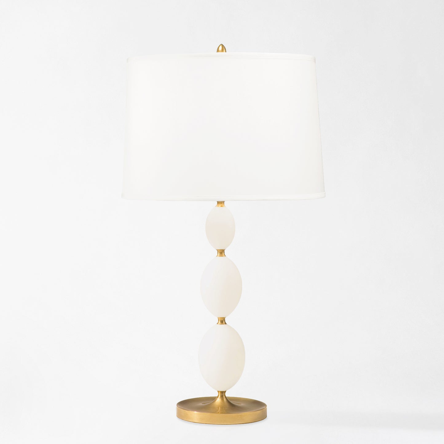 Brass and alabaster table lamp with white lamp shade.