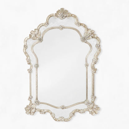 Antique Murano glass mirror with intricate details.