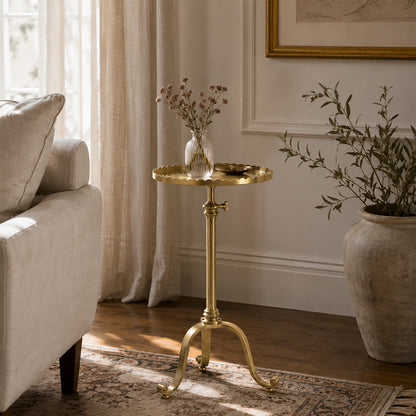 Antique brass accent table in luxurious living room.