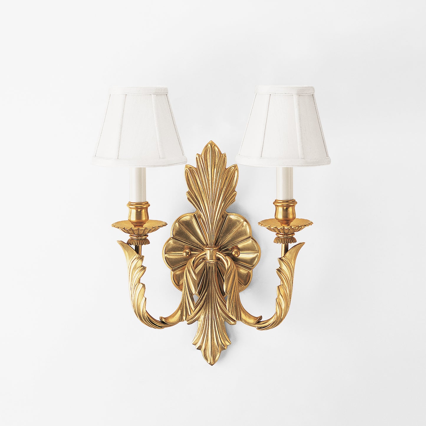 Antique brass sconce with white shades.