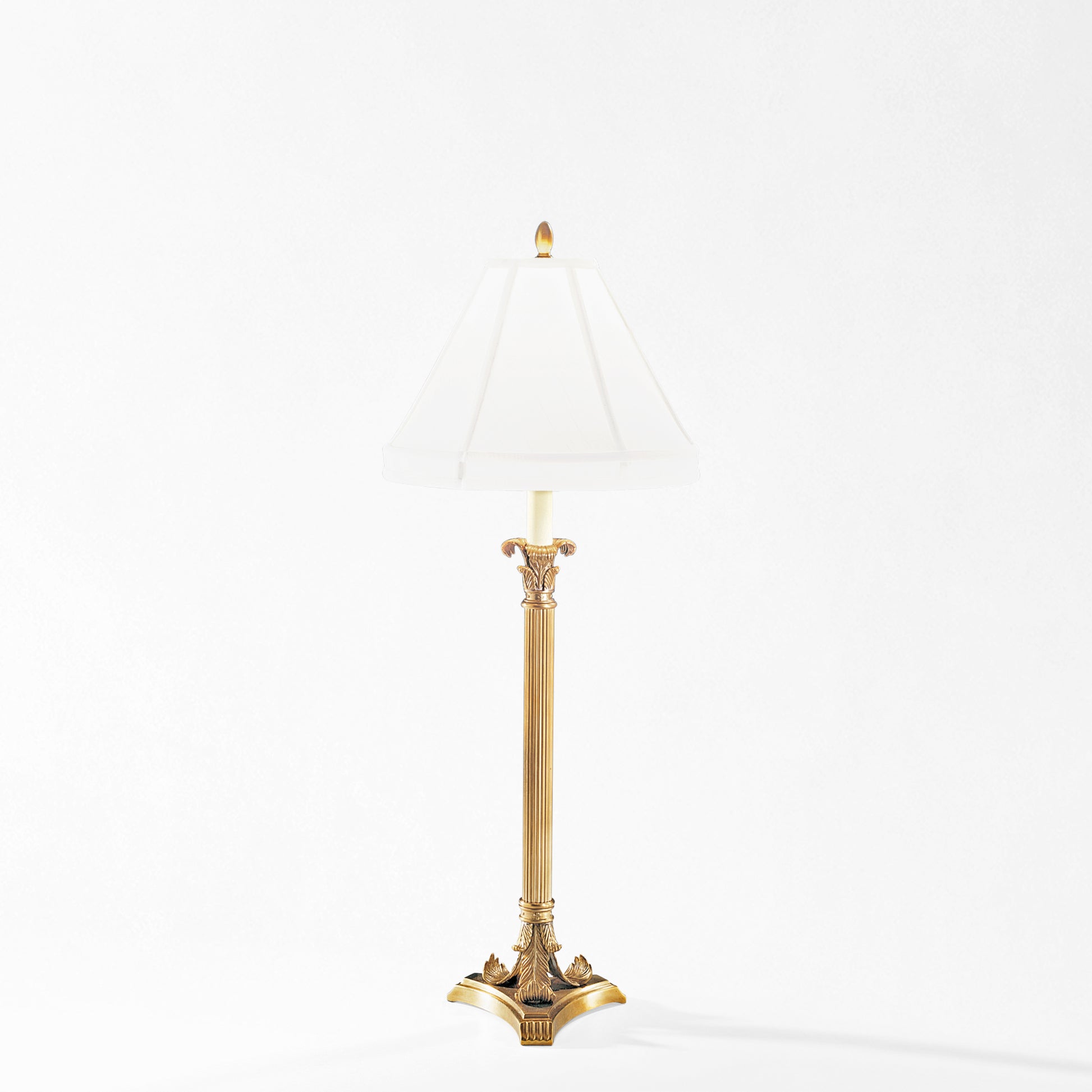 Antique brass table lamp with white lamp shade.