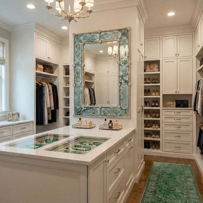 Antique green Murano glass mirror in luxurious walk-in closet with chandelier.