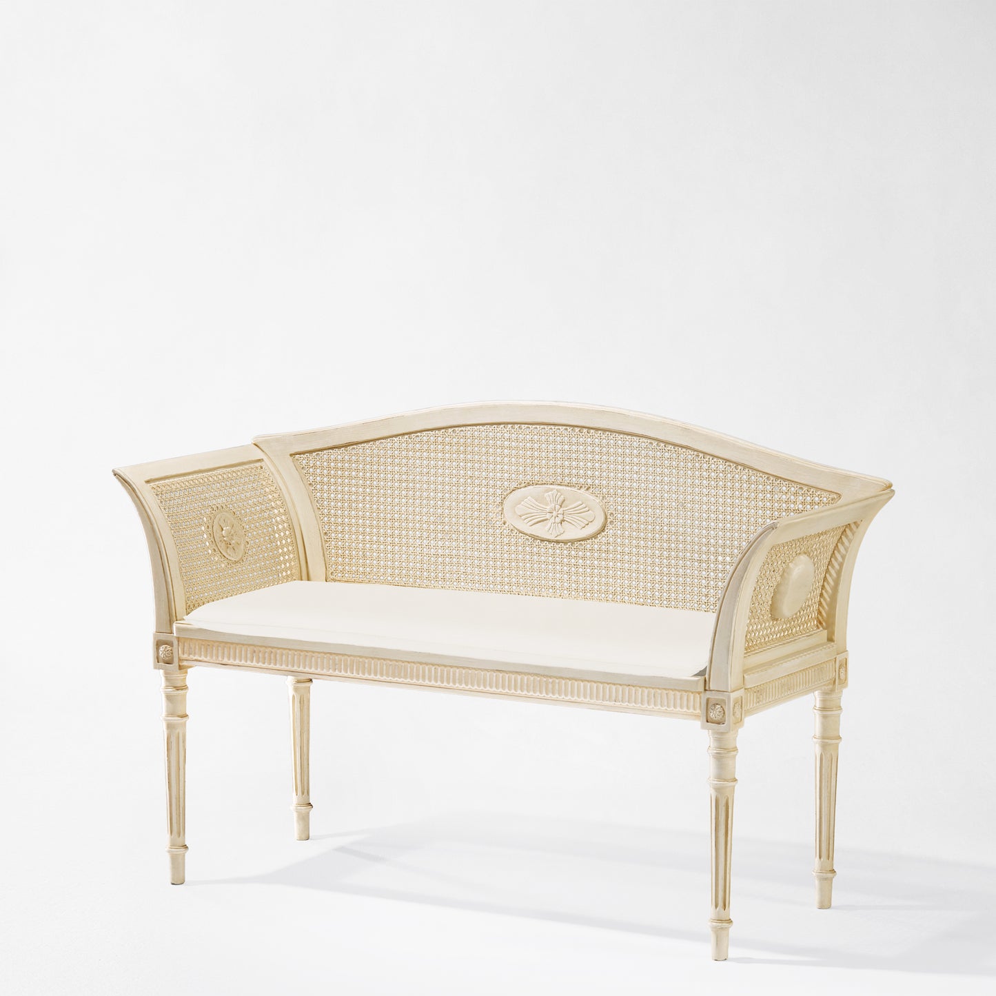 Antique white Italian bench with white cushion.