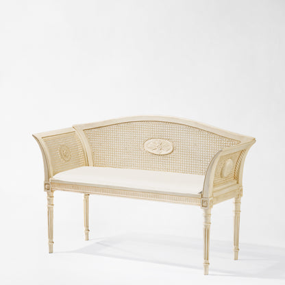 Antique white Italian bench with white cushion.