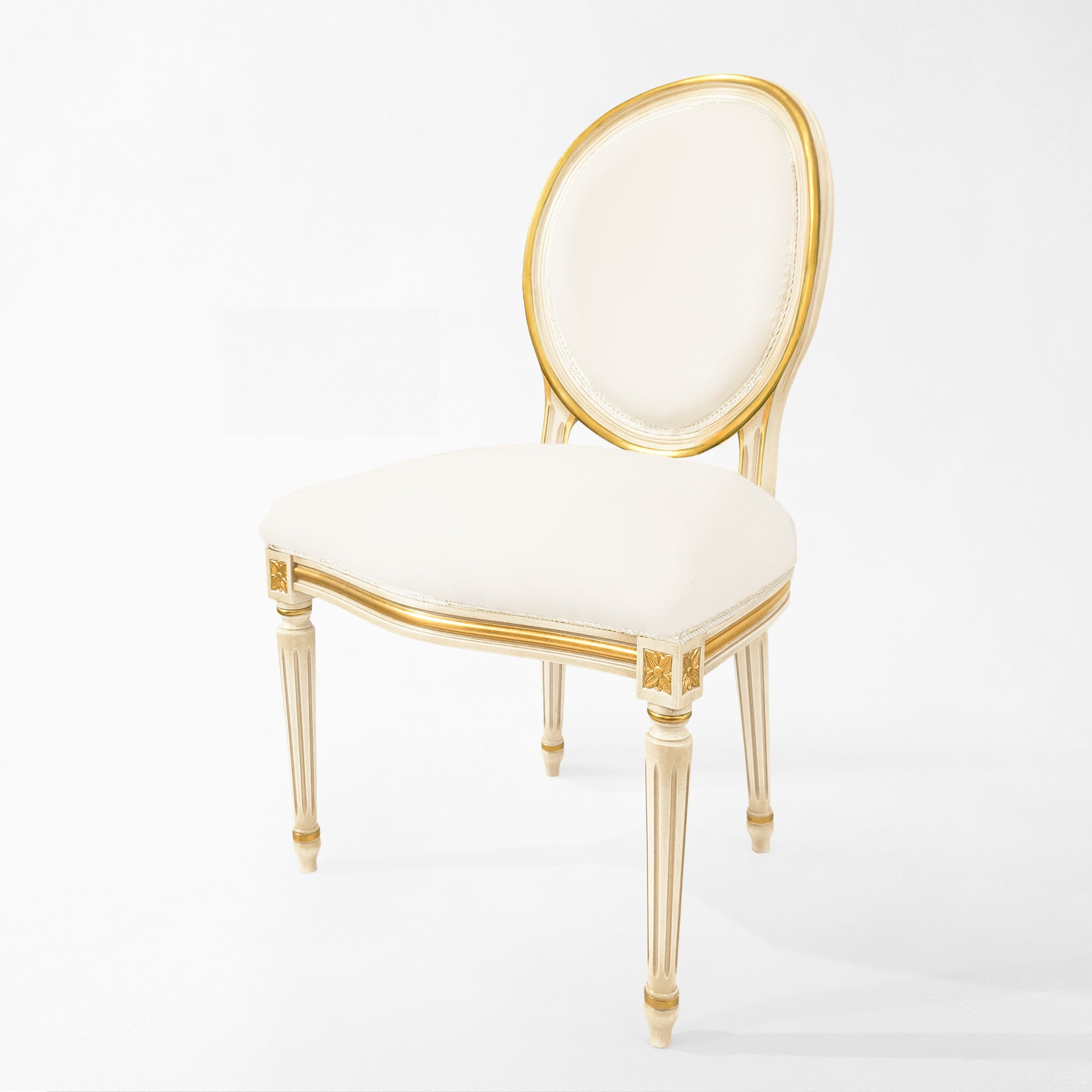 Antique white Italian chair with carved gold details and white fabric.