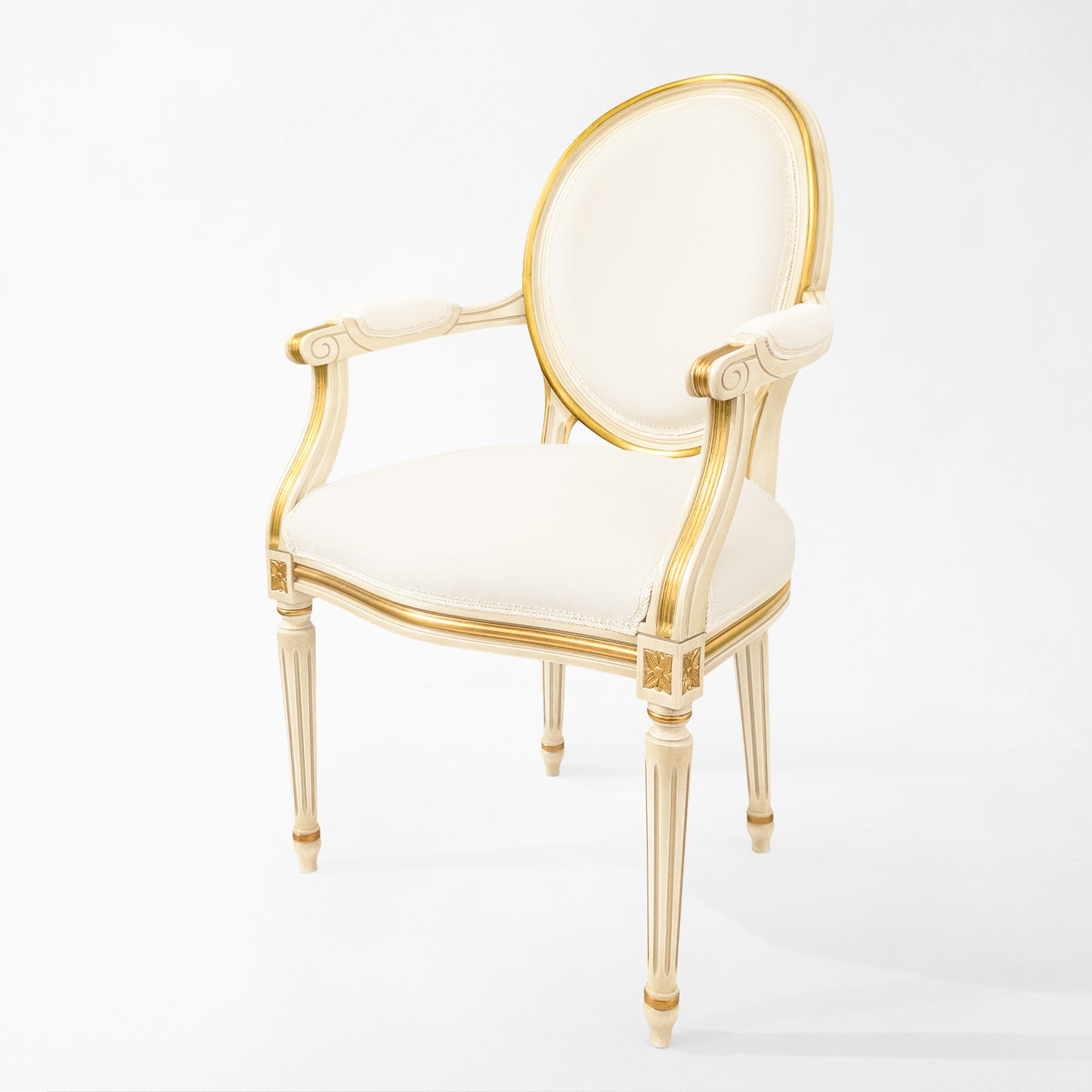 Antique white Italian chair with carved gold details and white fabric.