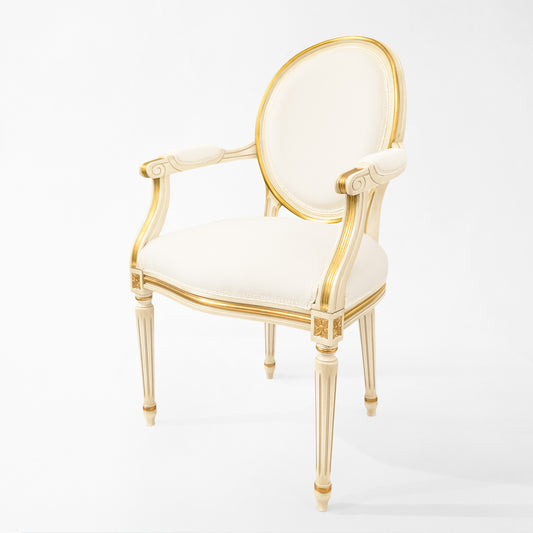 Antique white Italian chair with carved gold details and white fabric.