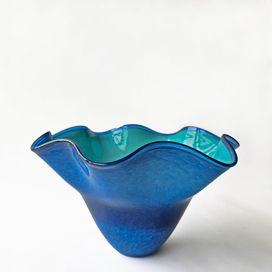 Aqua and blue decorative glass bowl with fluted design.