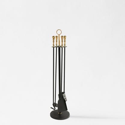 Black and brass fireplace tool set.