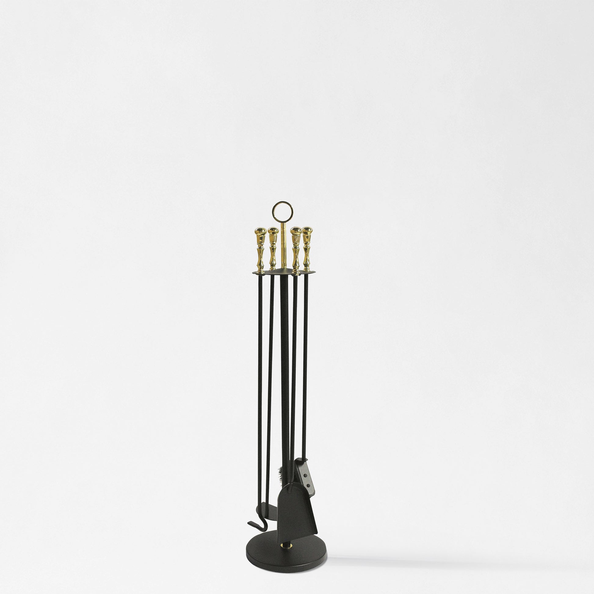 Black and brass fireplace tool set.