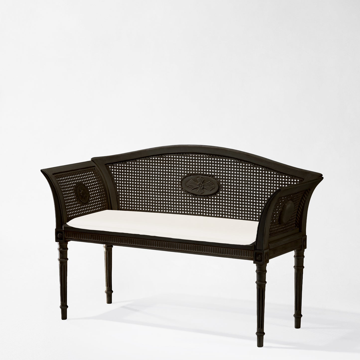 Italian black cane bench with white cushion.