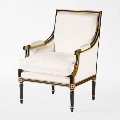 Black and gold armchair with white fabric.