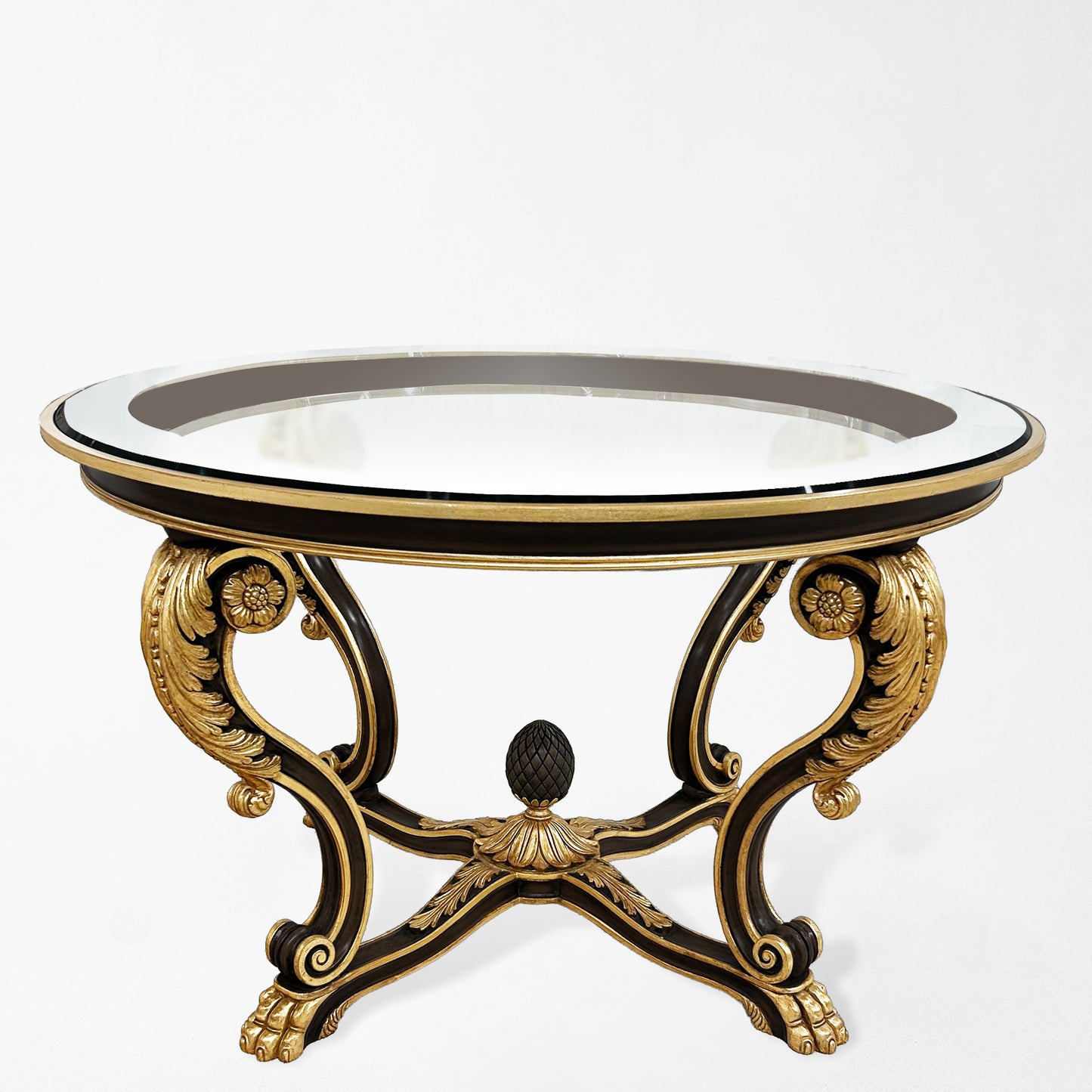 Ornate black center table with gold details and glass top.