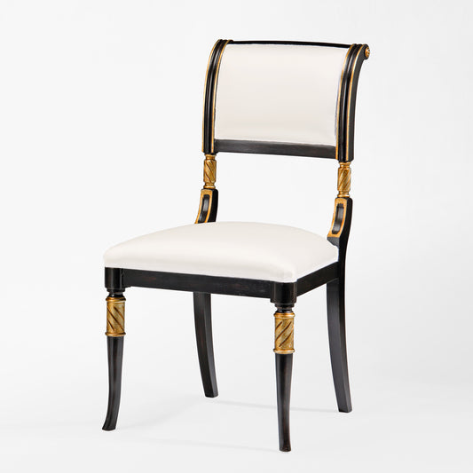 Black chair with gold details and white fabric.