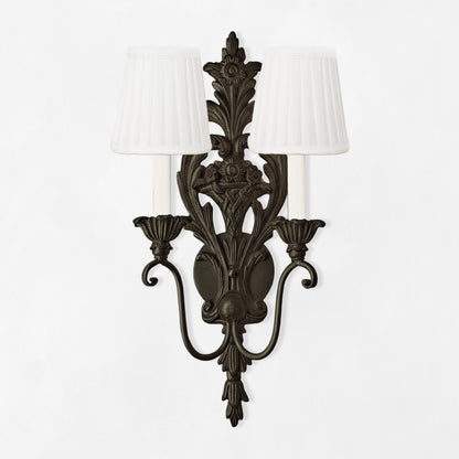 Black sconce with white pleated shades.