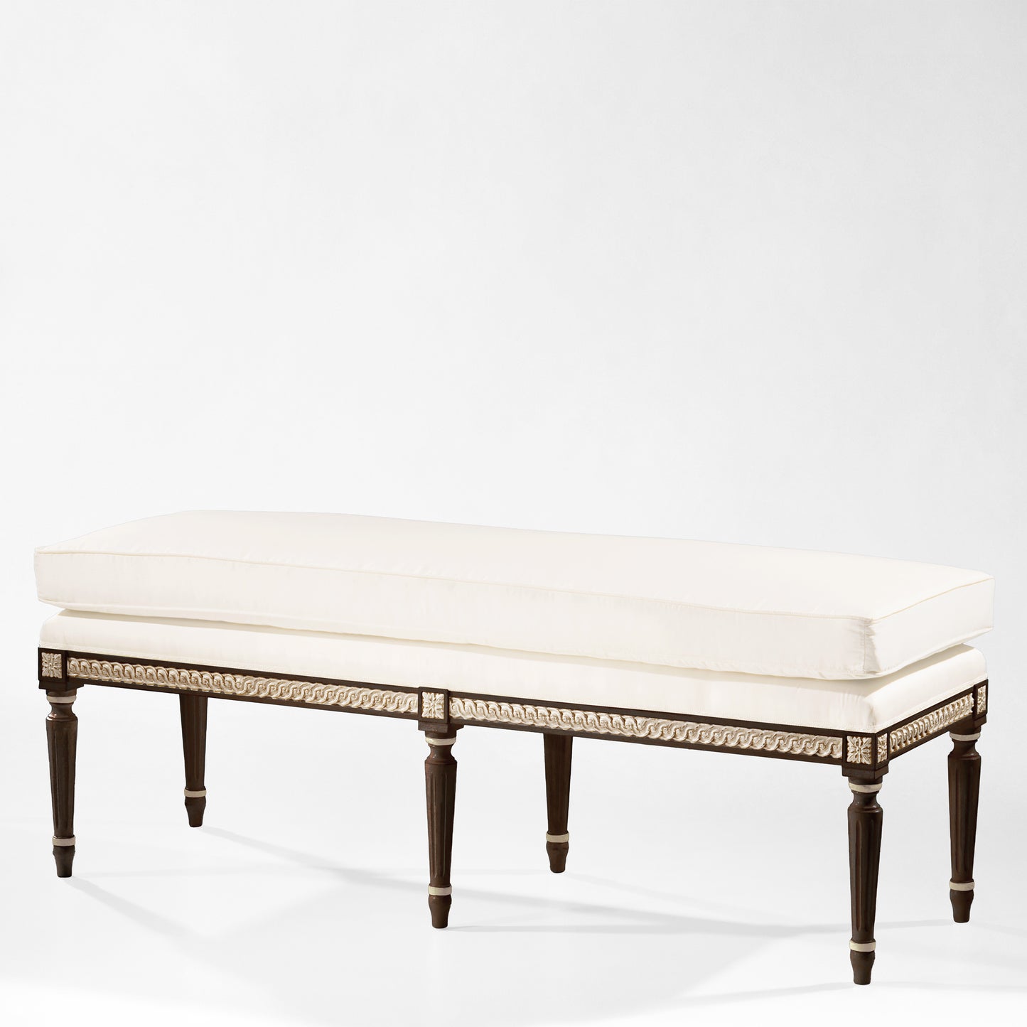 Traditional black bench with silver details and white fabric.