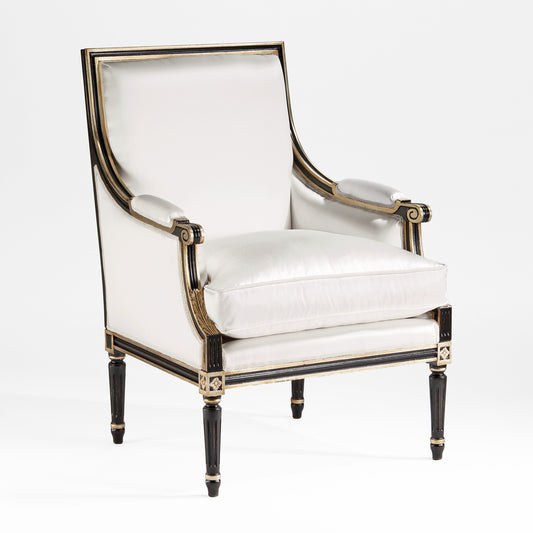 Black wood armchair with silver leaf trim and white fabric.