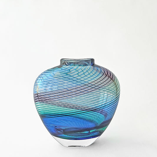 Aqua and blue glass vase with striped design.