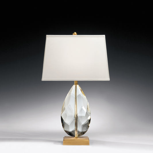Faceted crystal table lamp with antique brass accent.