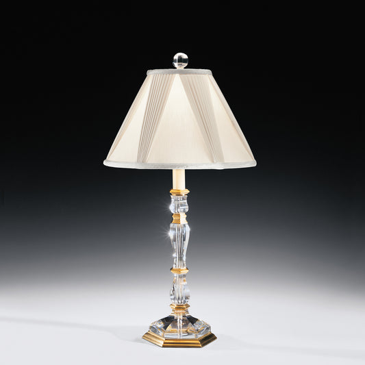 Crystal table lamp with antique brass accents and traditional pleated shade.