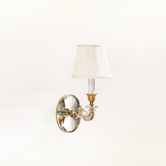 Antique brass and crystal wall sconce with traditional pleated shade.