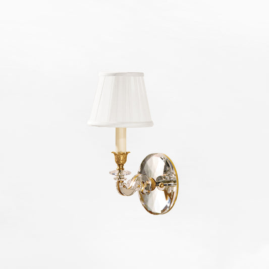 Brass and crystal wall sconce with pleated shade.