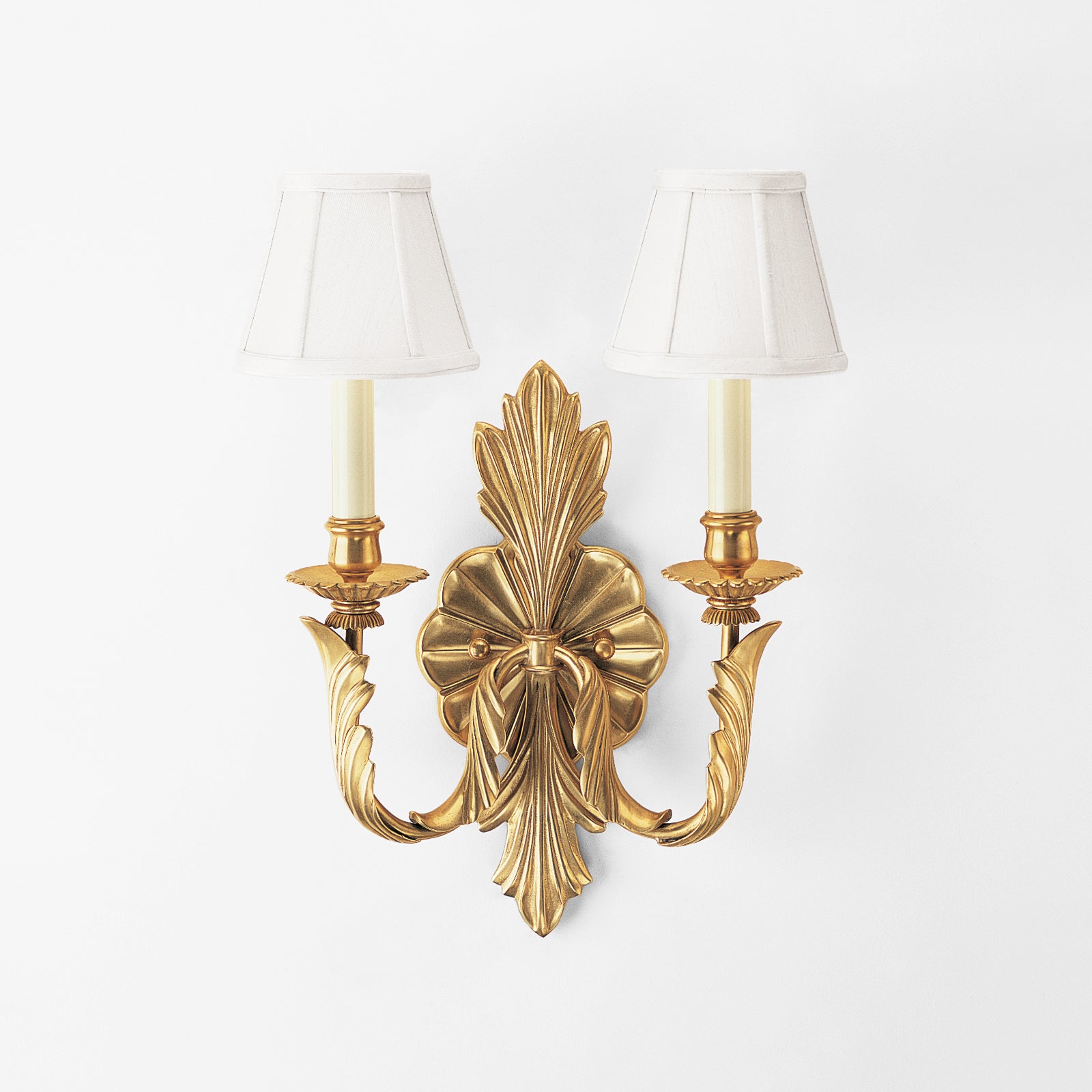 Antique brass sconce with white shades.