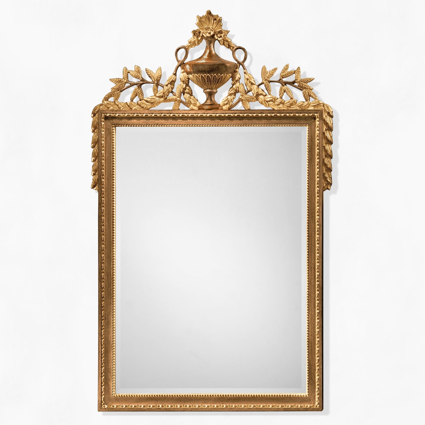 Brown traditional wood mirror with ornate carved gold details.