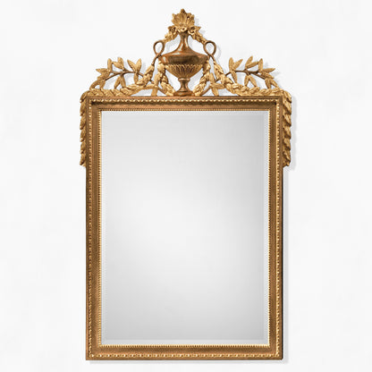 Brown traditional wood mirror with ornate carved gold details.
