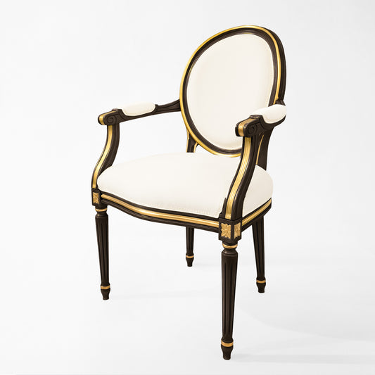 Carved wood Italian black chair with gold details and cream fabric.