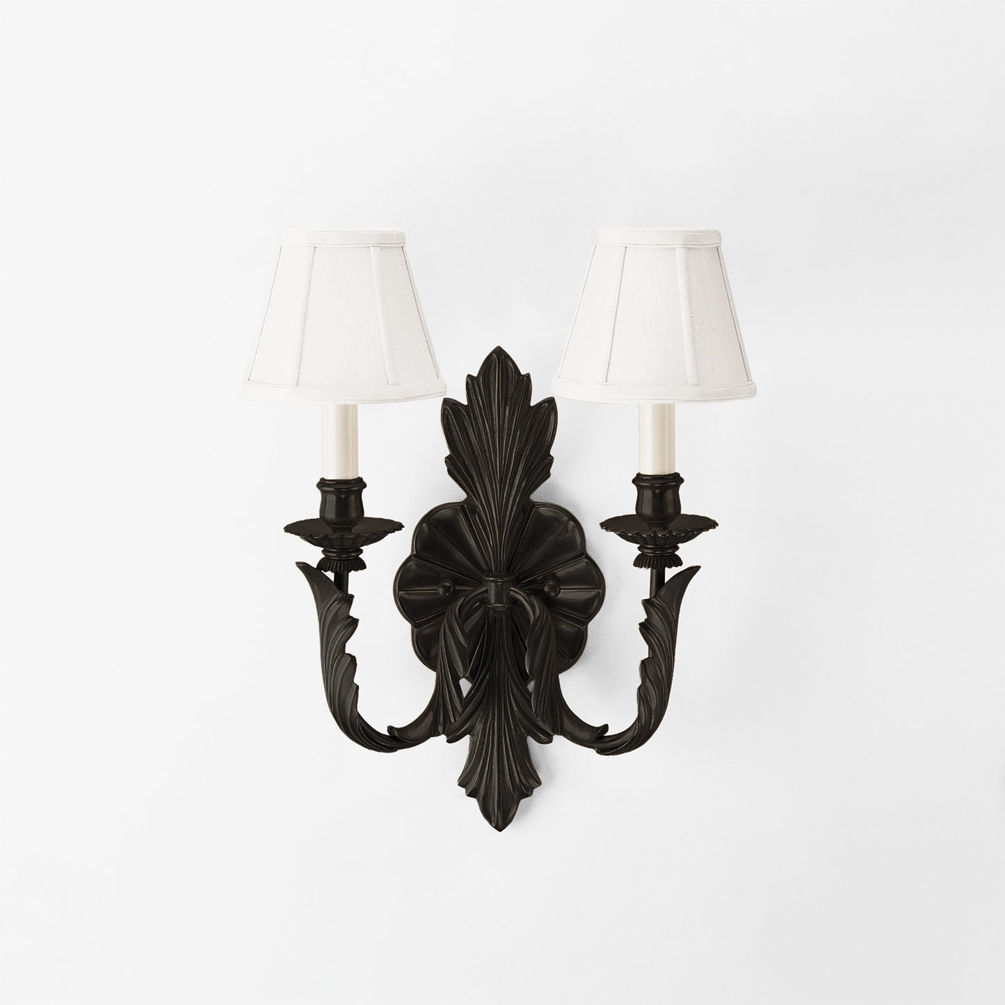 Traditional black, brass sconce with white lampshades.