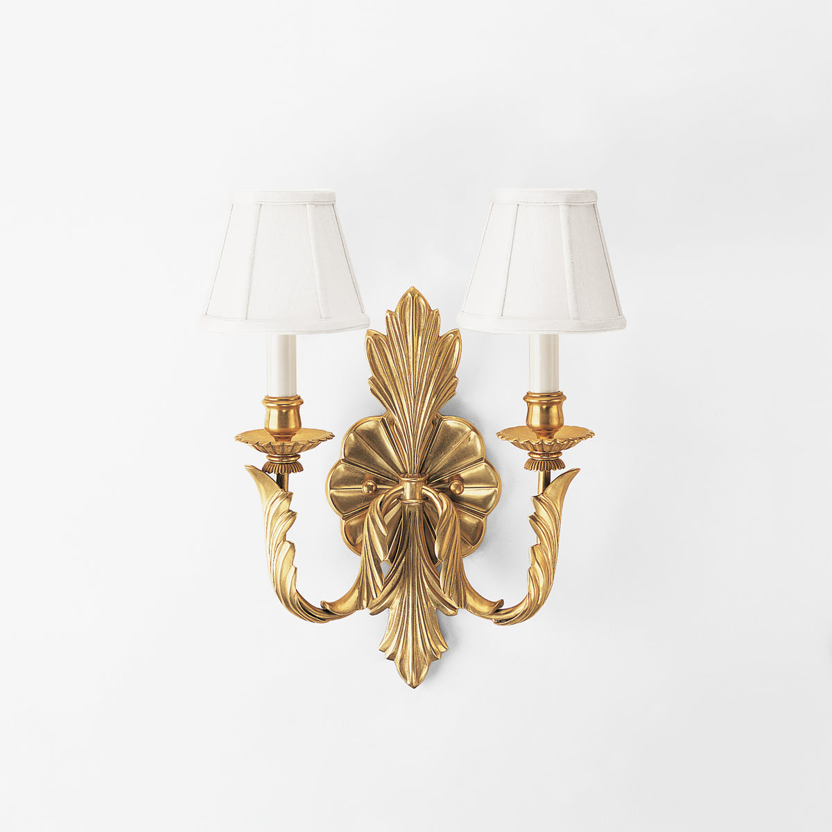 Luxurious brass sconce with white shades.