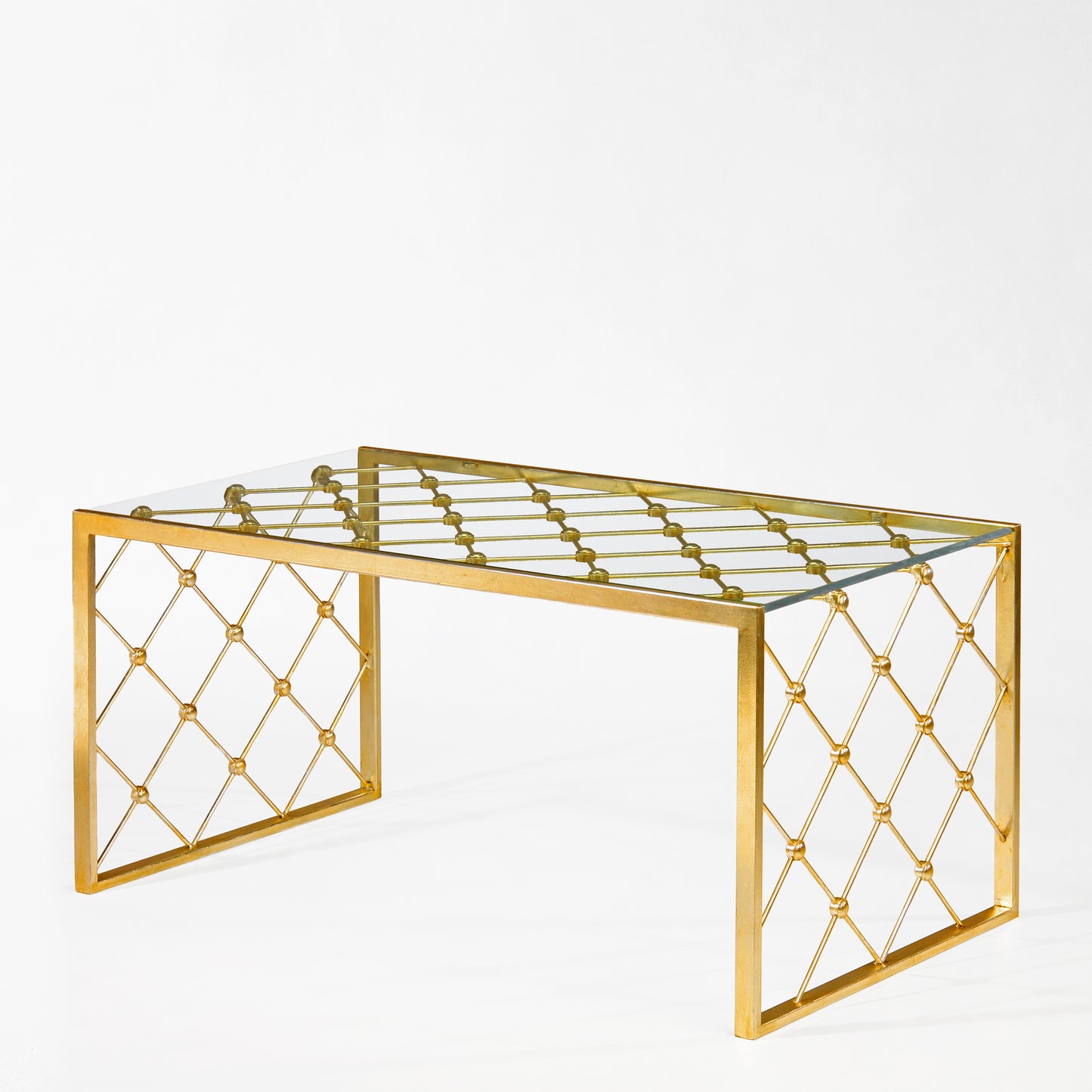 Gold coffee table with glass top.