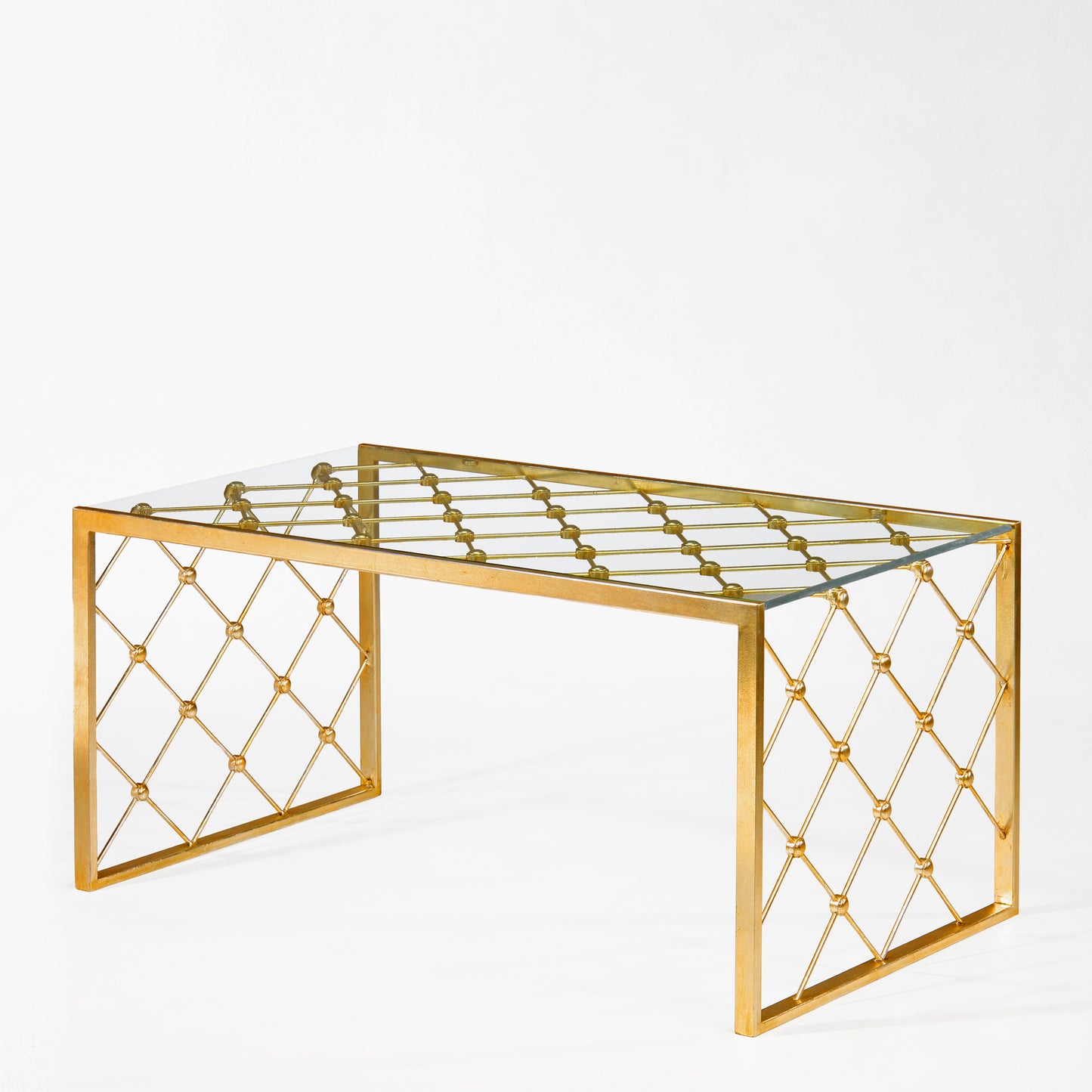 Gold coffee table with glass top.