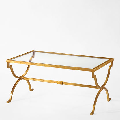 Gold coffee table with glass top.