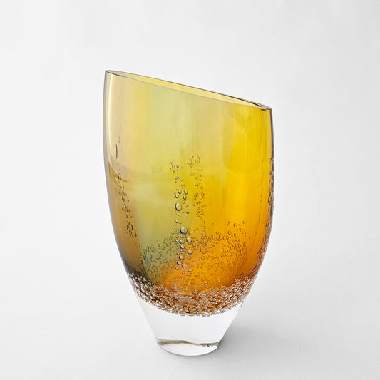 Gold glass vase with slanted top.