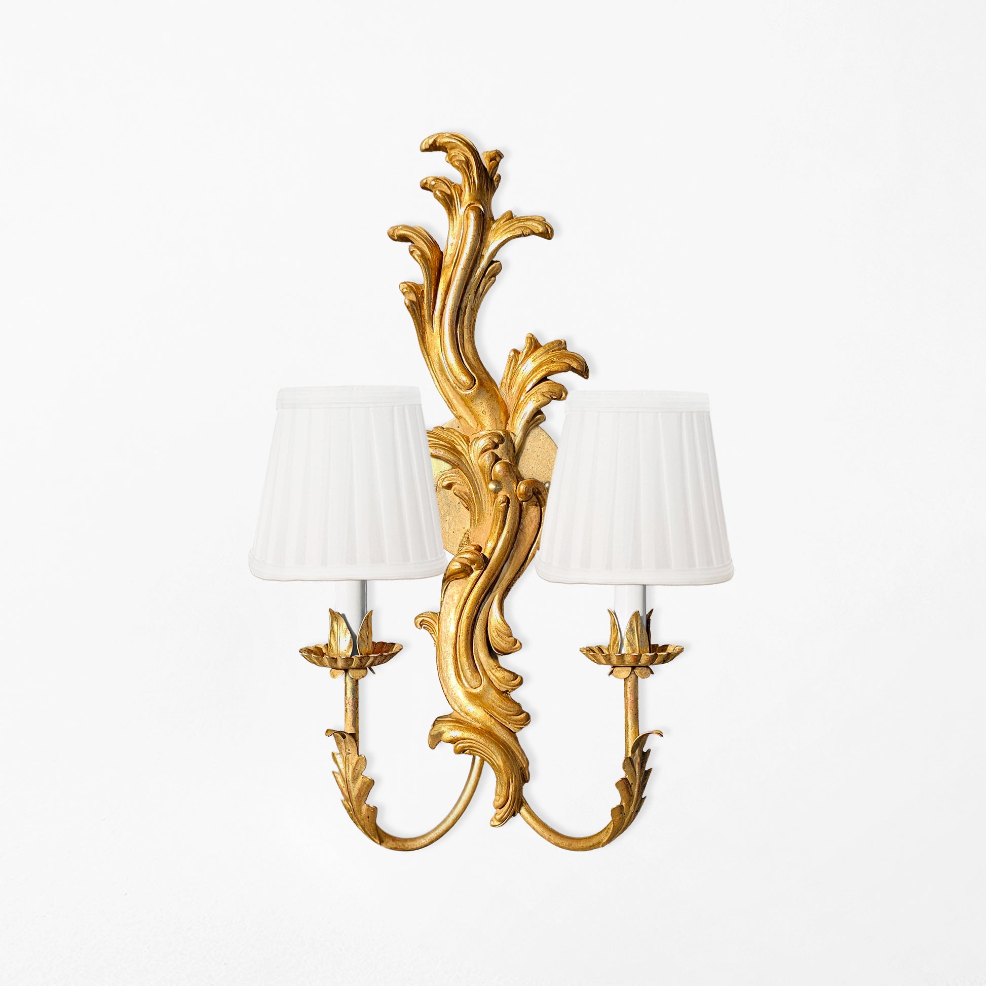 Traditional gold Italian sconce with white pleated shades.