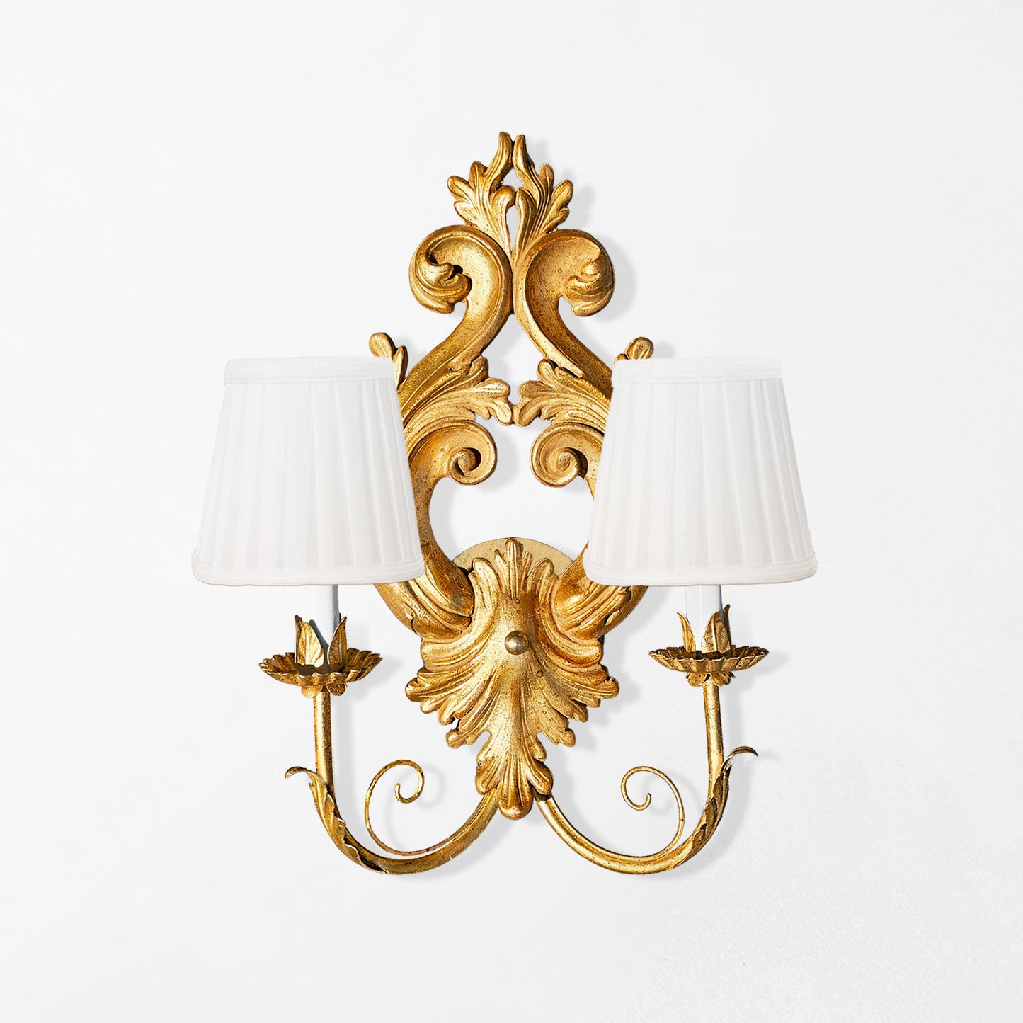 Traditional gold sconce with white pleated shades.