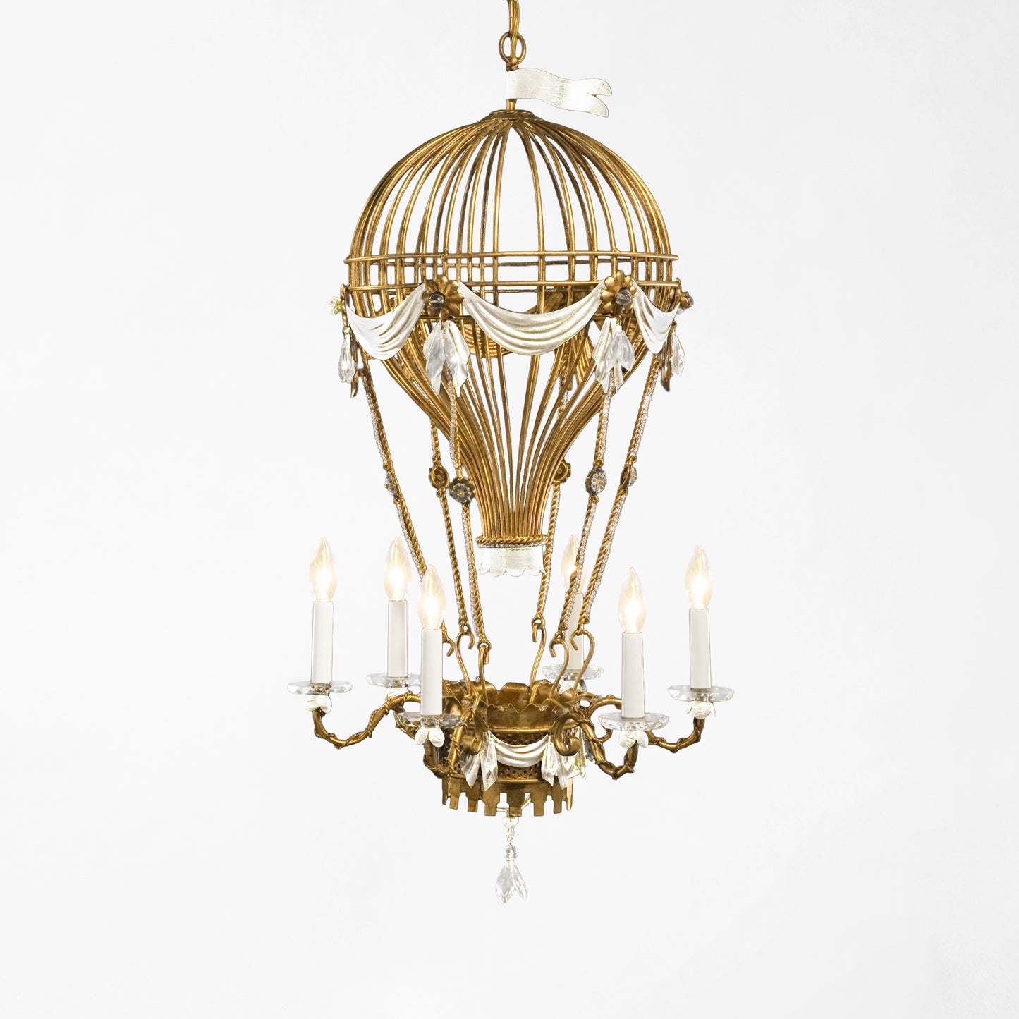 Gold hot air balloon chandelier with white details.