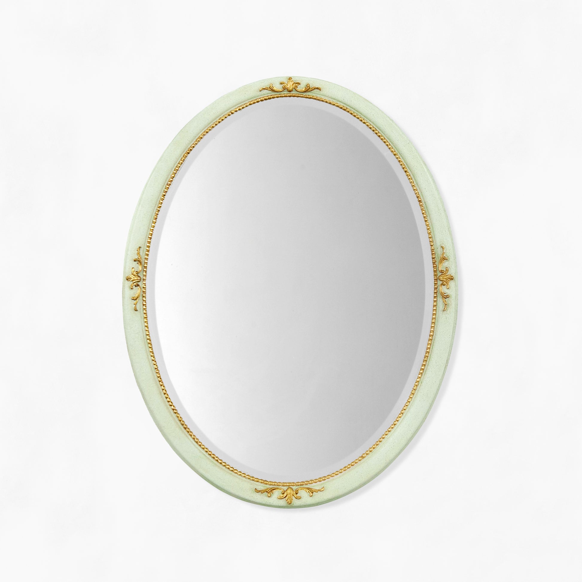 Decorative light green oval mirror with gold details.