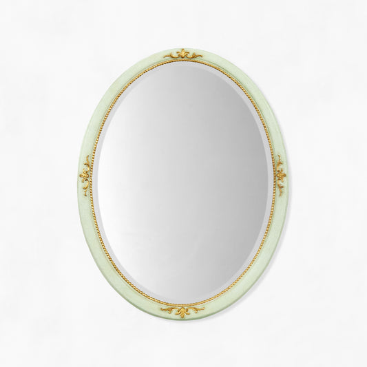 Decorative light green oval mirror with gold details.