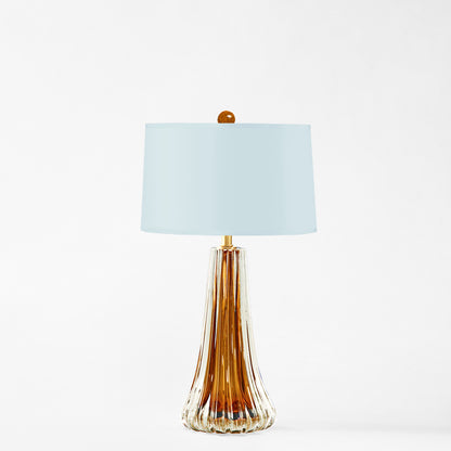 Amber Murano glass table lamp with light blue lamp shade.