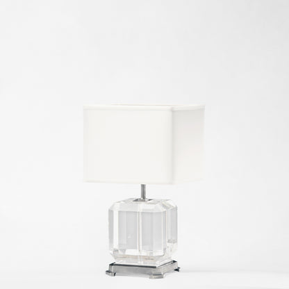 Crystal table lamp with polished nickel trim and white lamp shade.