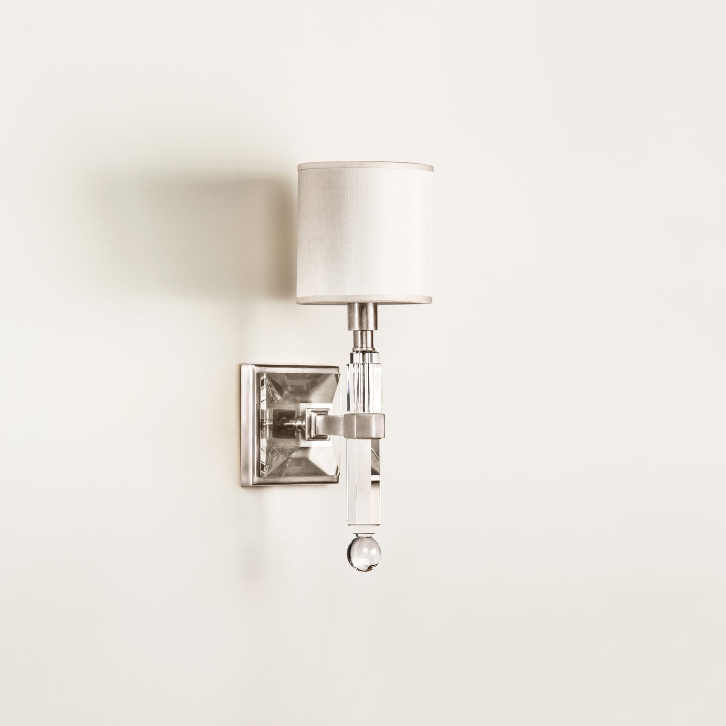 Crystal and polished nickel wall sconce.
