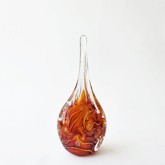 Orange glass teardrop decor.