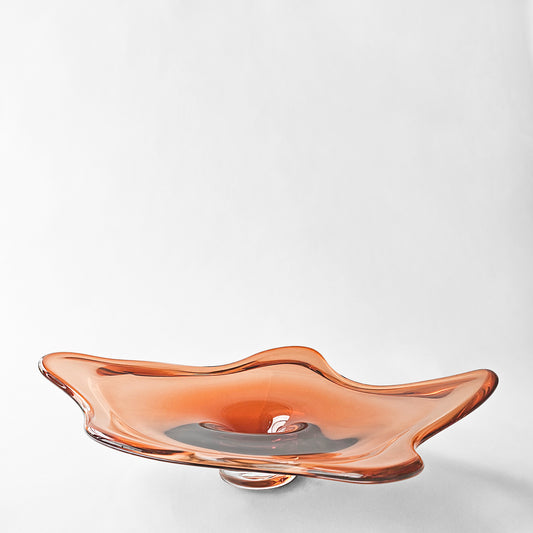 Orange glass decorative platter with modern design.